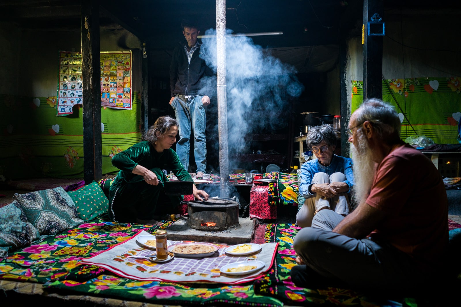 Homestay in Pakistan - Sitara cooking on the stove in the middle of the traditional home - Lost With Purpose travel blog