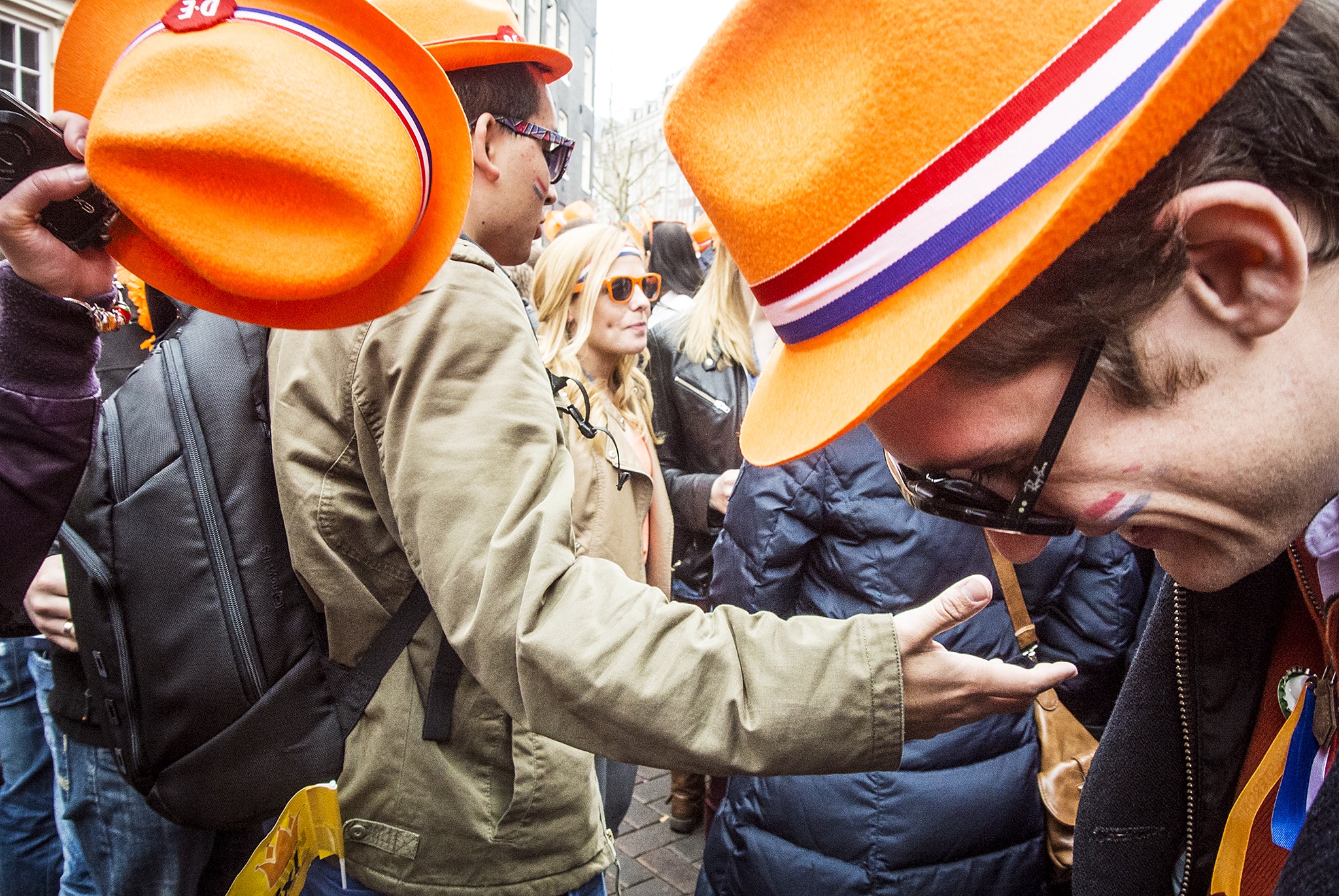 People wearing orange hats on the street for King's Day