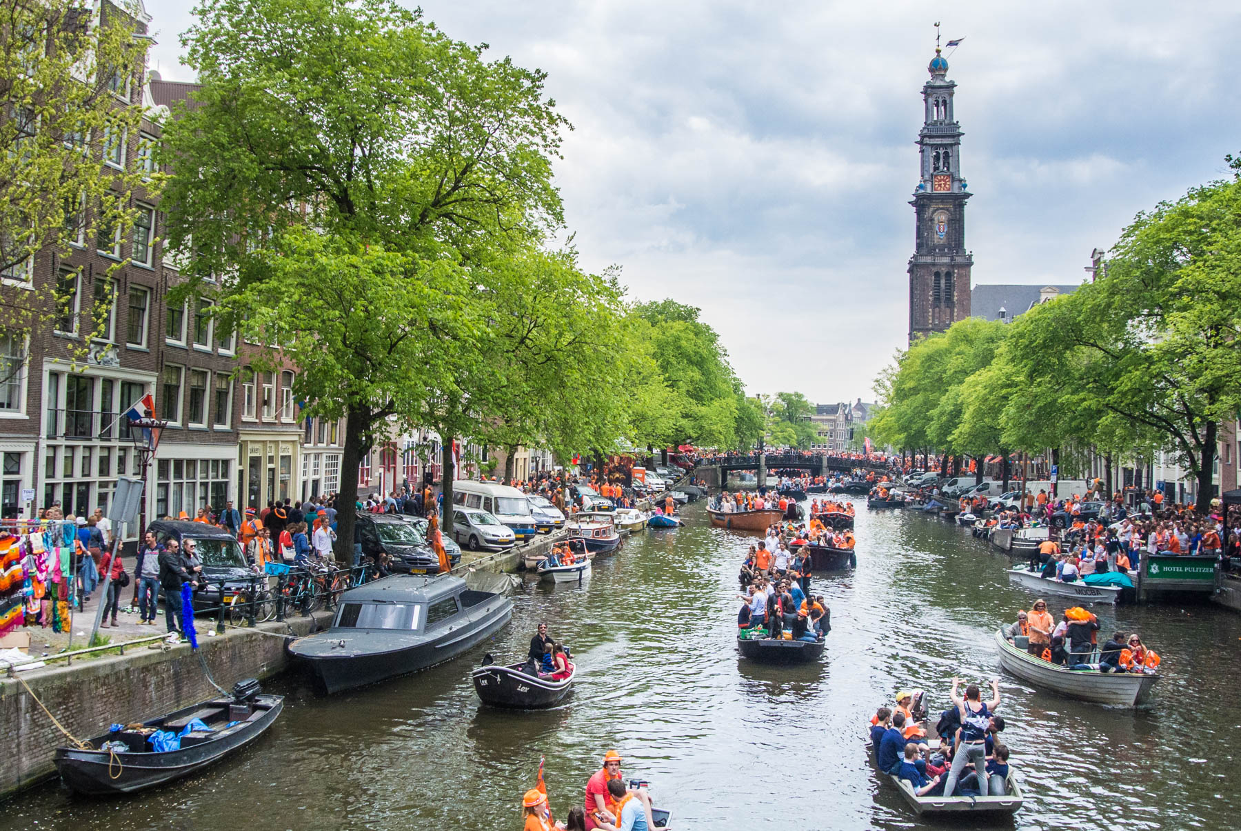 Boats in the canals in Amsterdam during King's Day