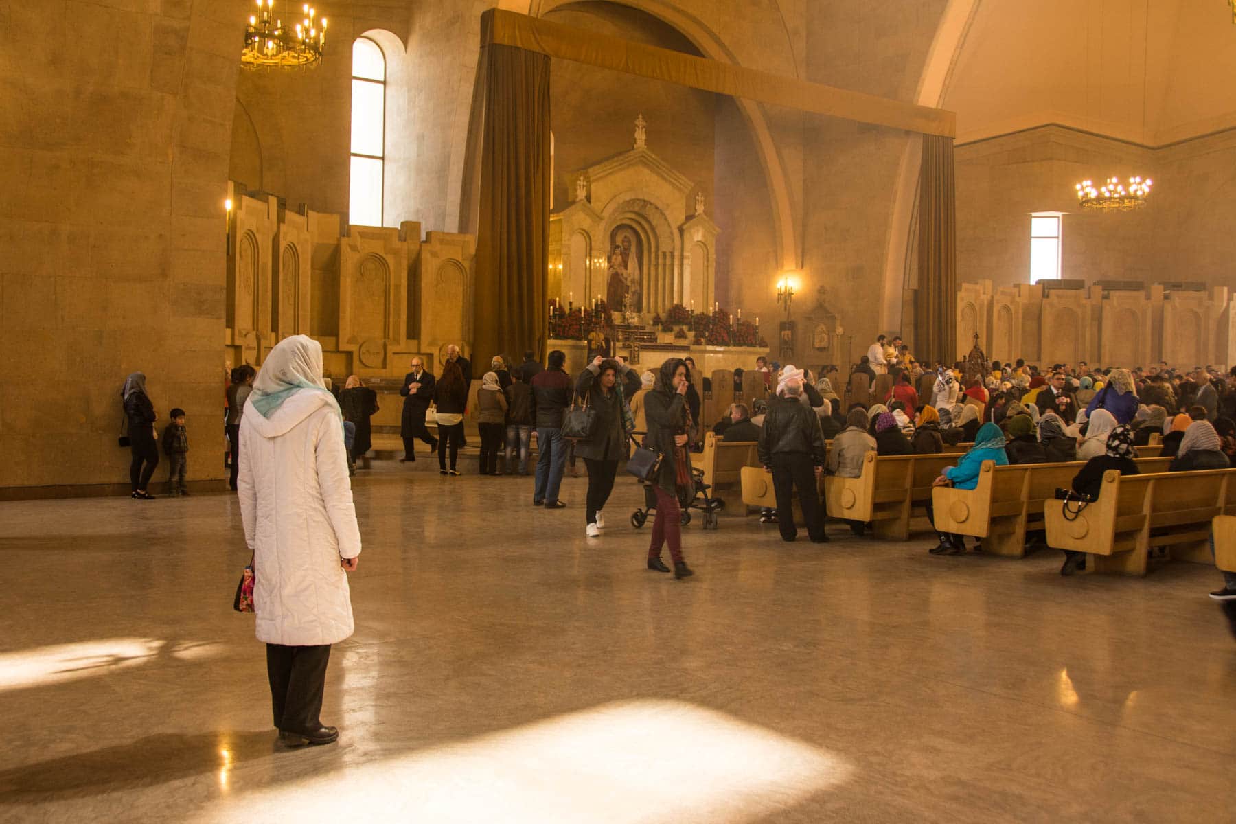 Easter in Armenia - A woman standing and observing mass in Gregory the Illuminator Cathedral in Yerevan for Easter in Armenia