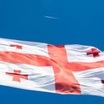 An airplane and the Georgian flag in Akhaltsikhe, Georgia