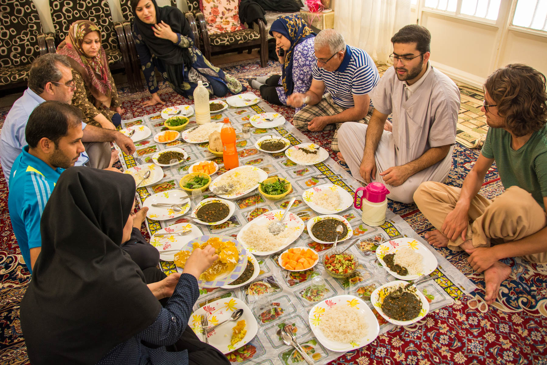 People sitting down for a traditional Iranian dinner