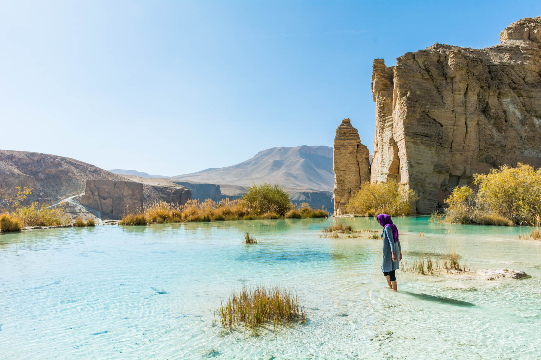 A girl standing in one of the lakes of Band-e-Amir in Afghanistan