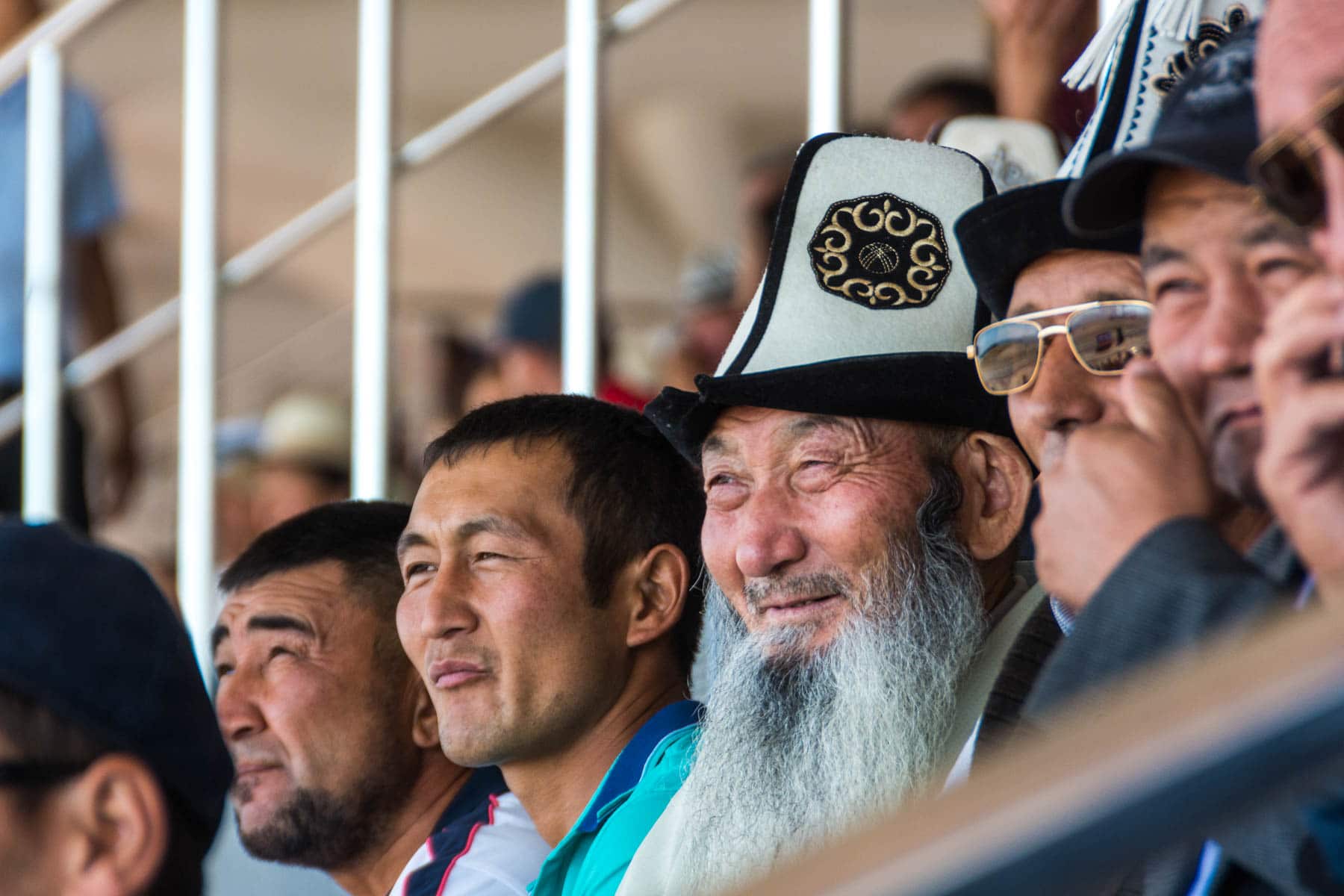 A bossy old Kyrgyz man wearing a traditional hat