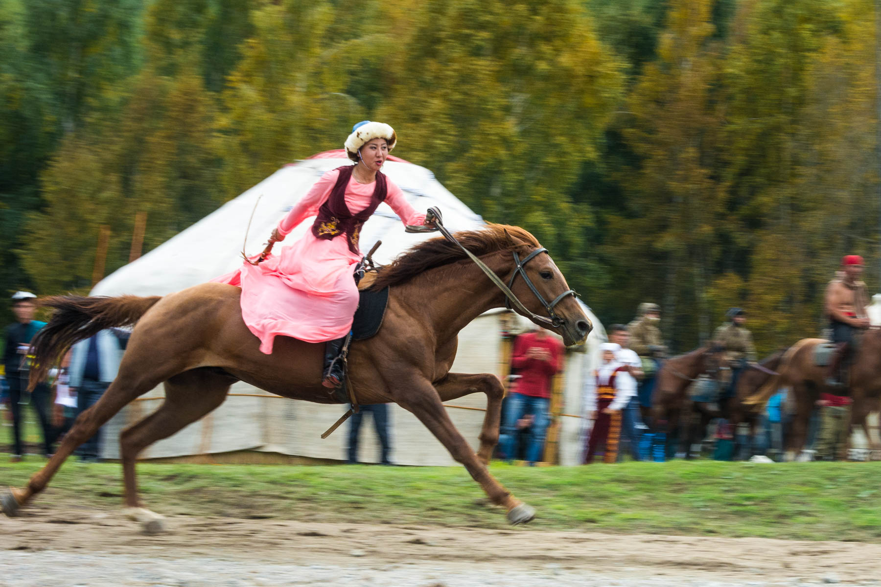 A performing woman riding a horse in Kyrgyzstan