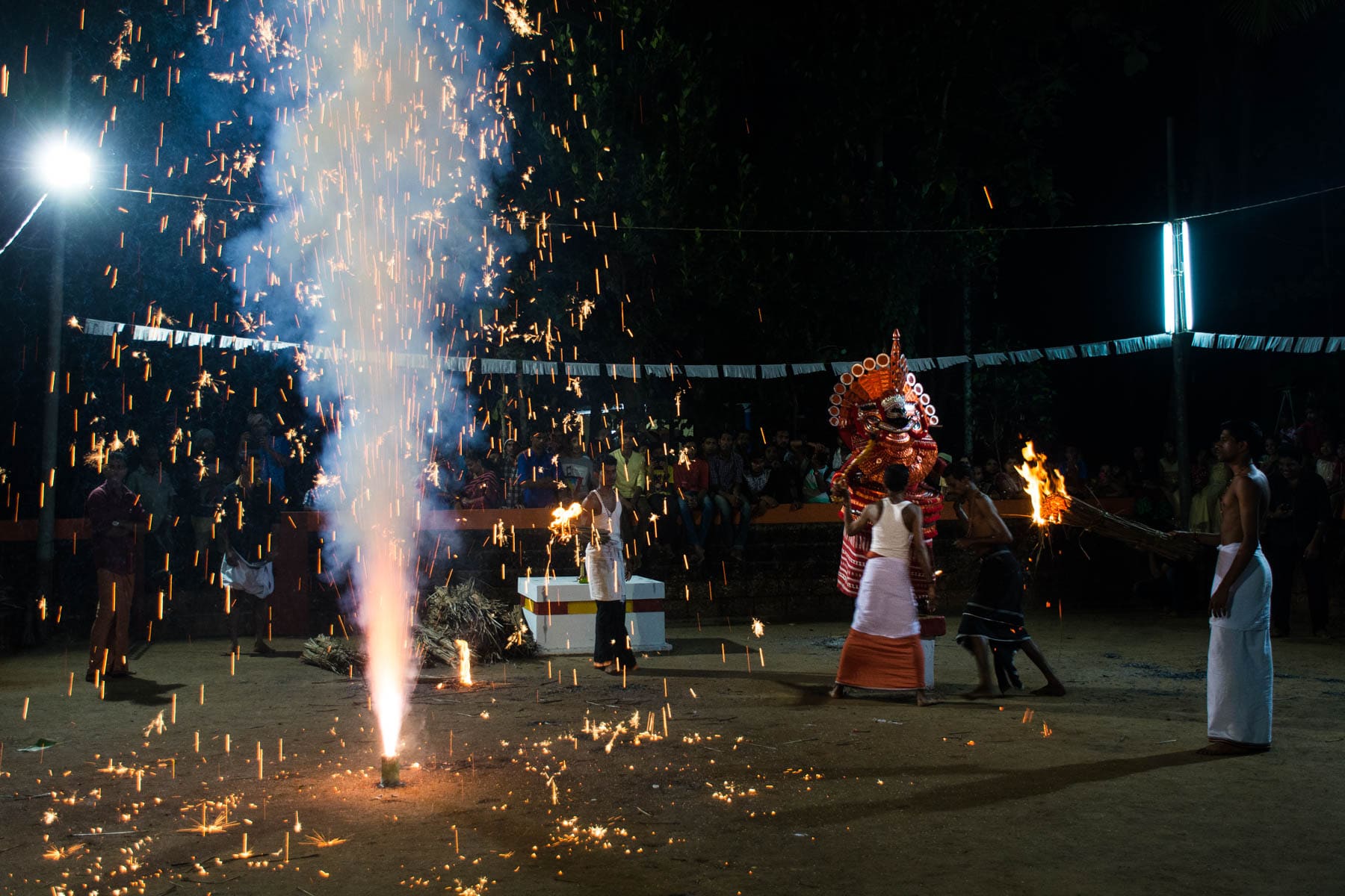 Fireworks going off during a Theyyam performance