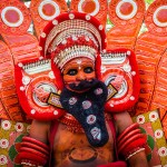 A man in costume at a performance of Theyyam in Kerala, India - Lost With Purpose