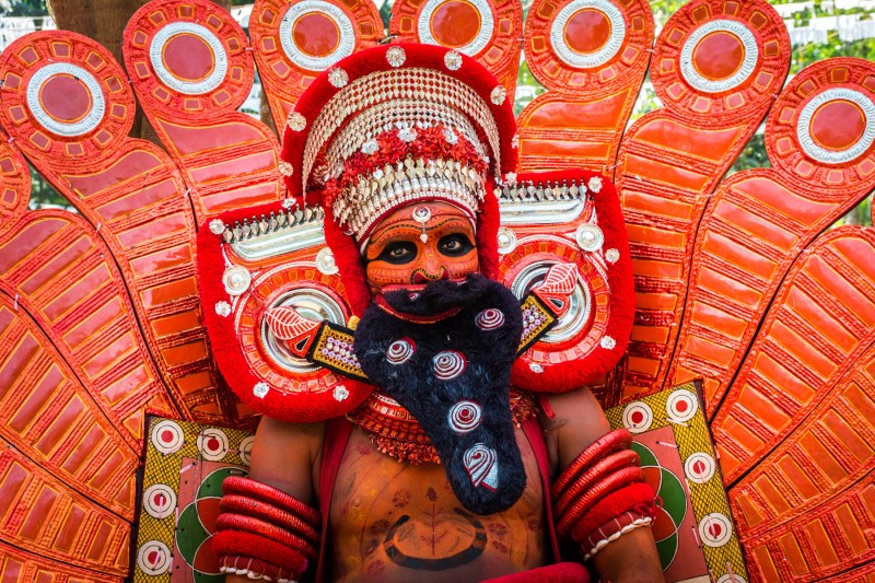 A man in costume at a performance of Theyyam in Kerala, India - Lost With Purpose