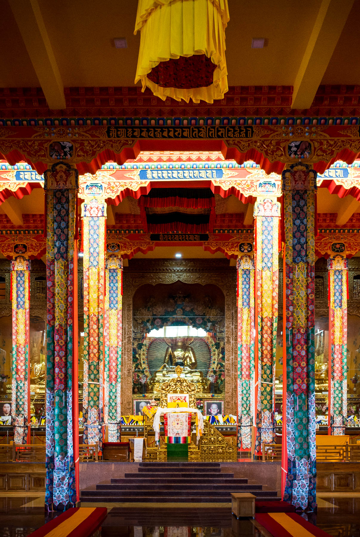 The interior of the serene Tashi Lhunpo monastery, a Buddhist monastery in Bylakuppe, India's second largest Tibetan settlement. Bylakuppe is a great destination to visit if you're looking for off the beaten track places in Karnataka state!