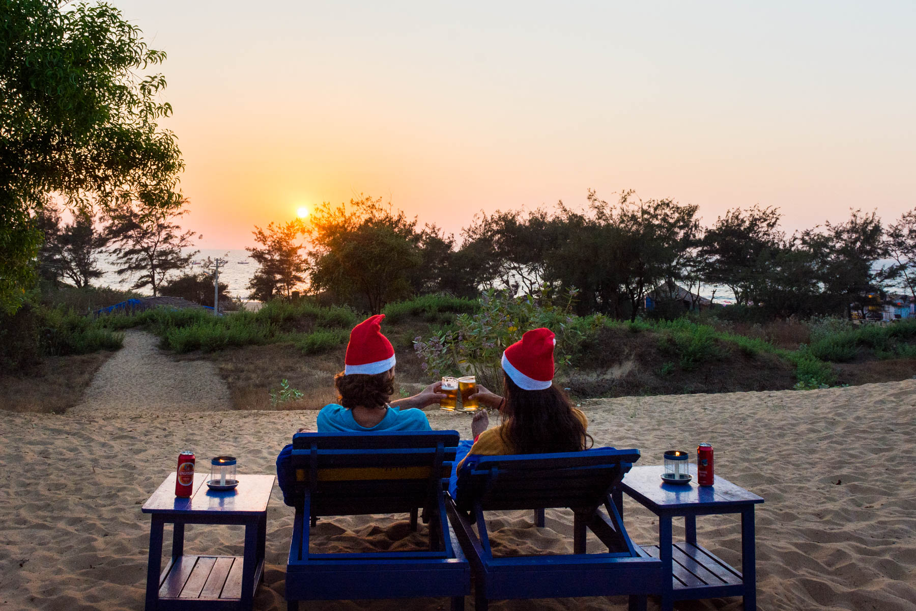 Two people having a drink on the beach