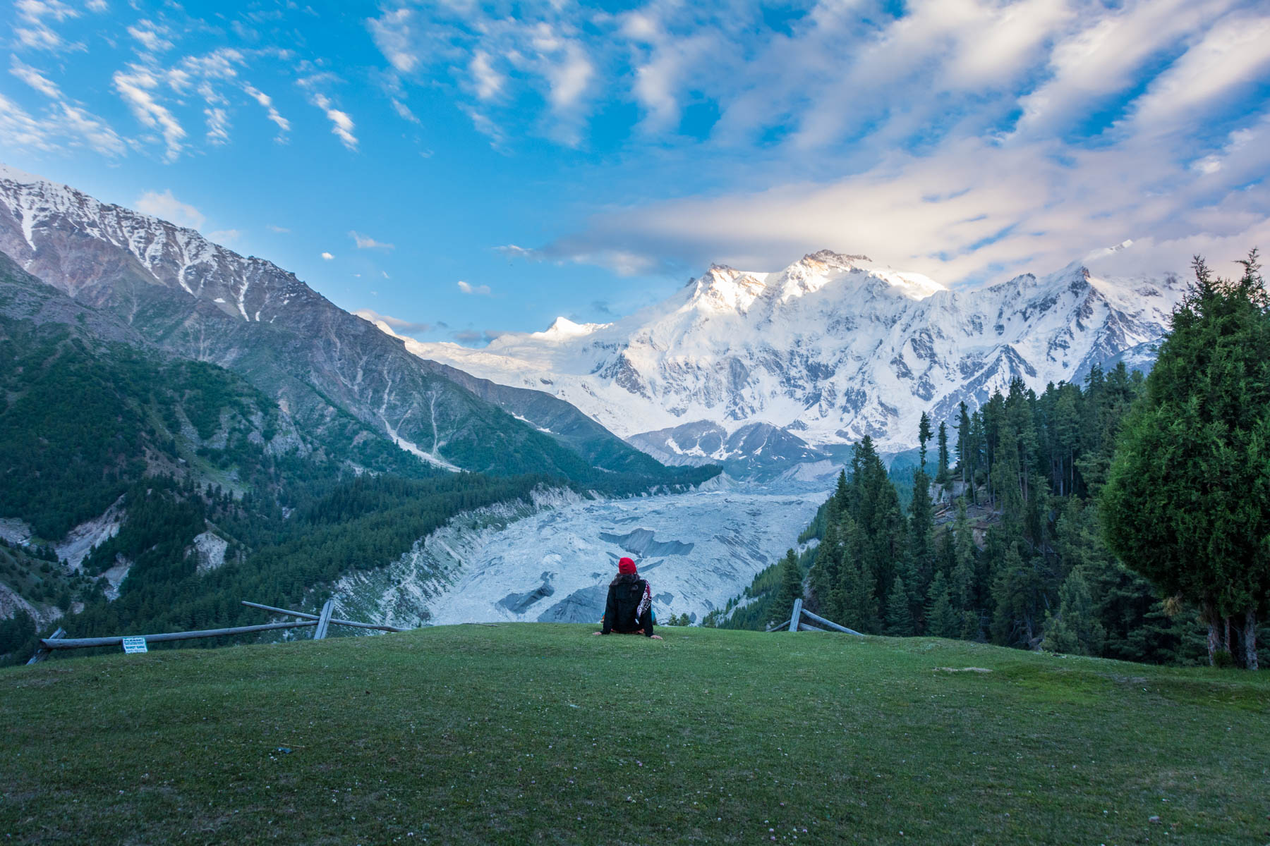 Solo female traveler checking out the sunset in Fairy Meadows, Pakistan