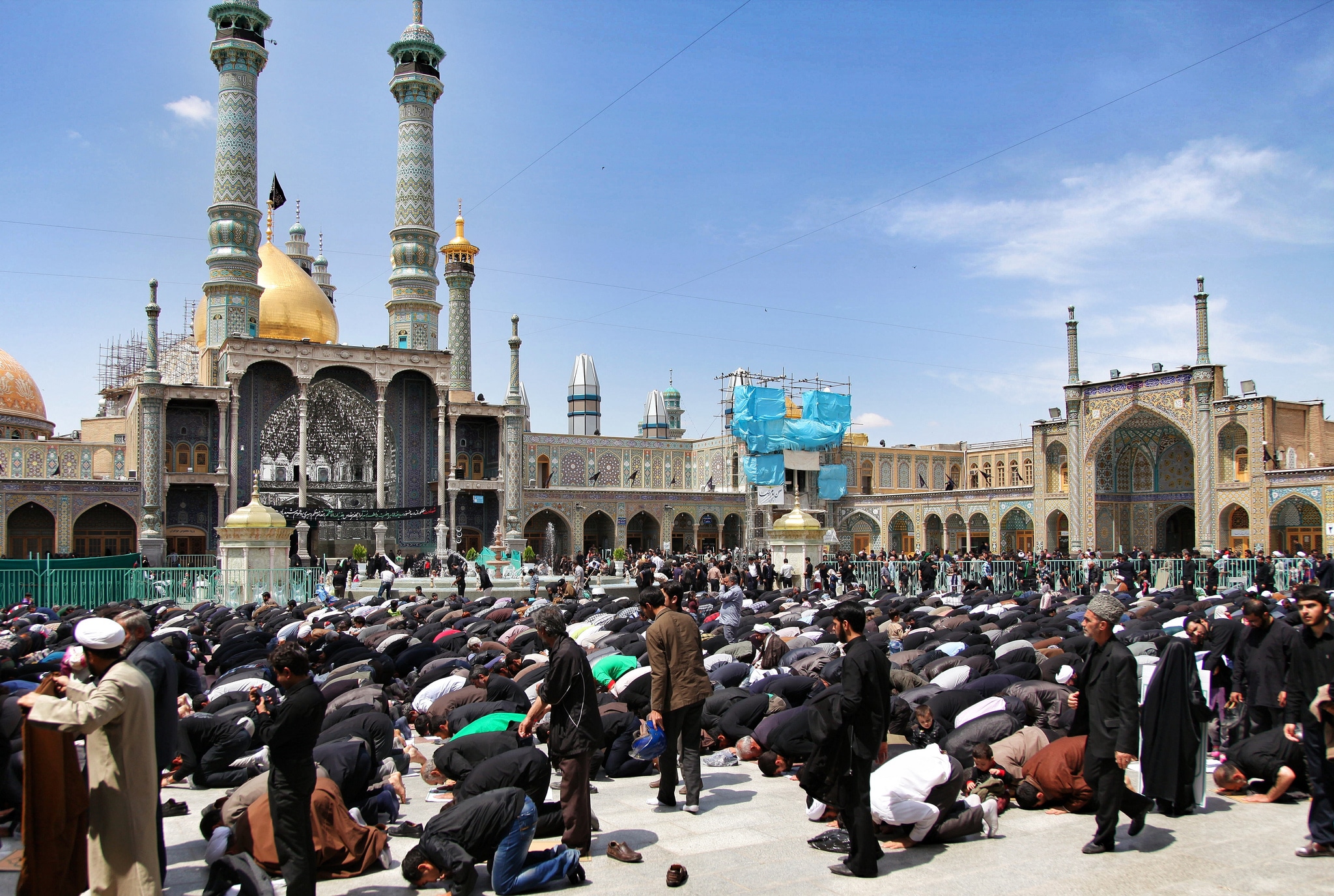 Two week Iran travel itinerary - Men praying at Hazrat-e Masumeh shrine in Qom, Iran - Lost With Purpose