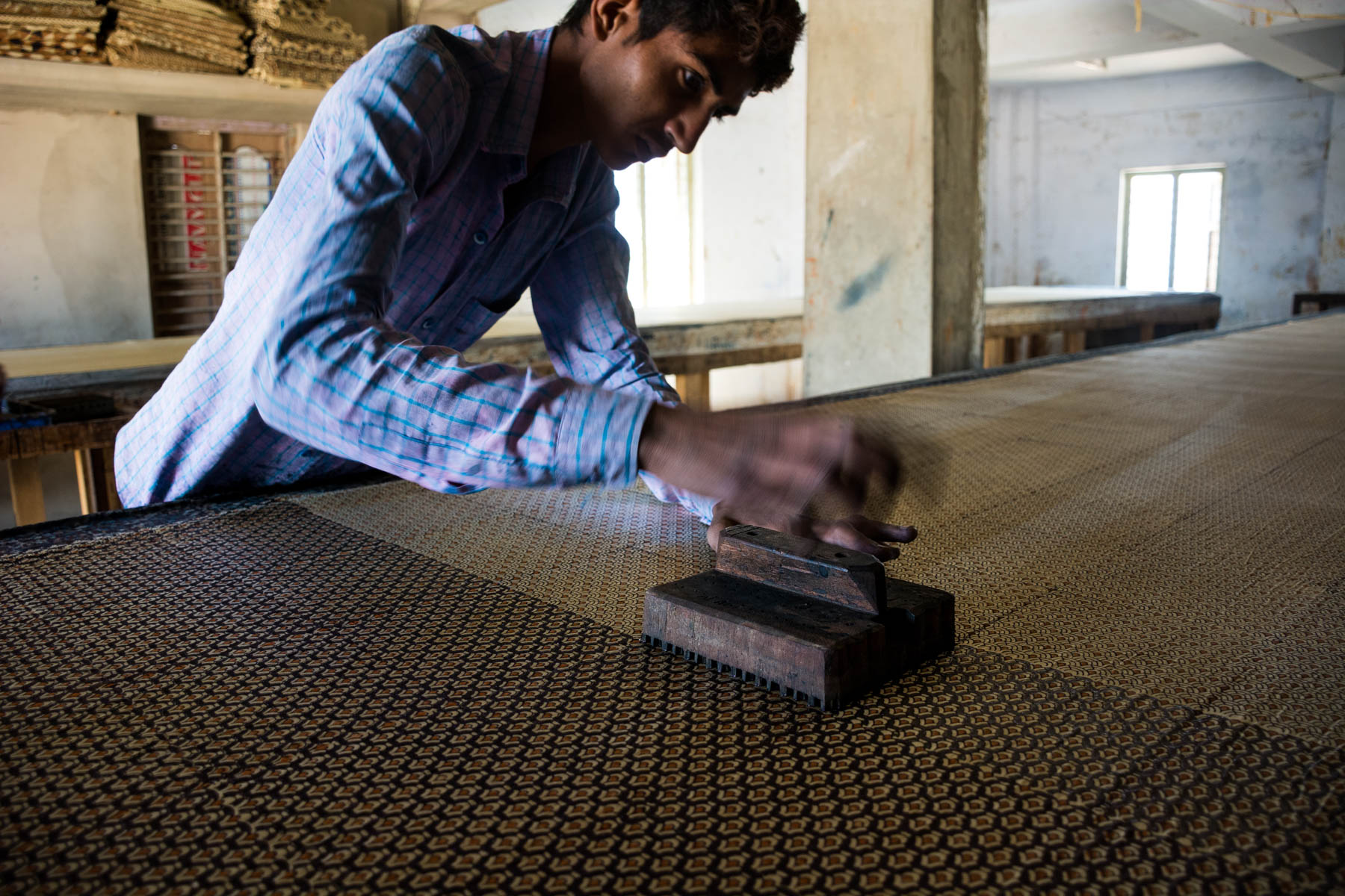 Textiles and crafts of Kutch, Gujarat, India - A man block printing by hand in Ajrakhpur, India - Lost With Purpose