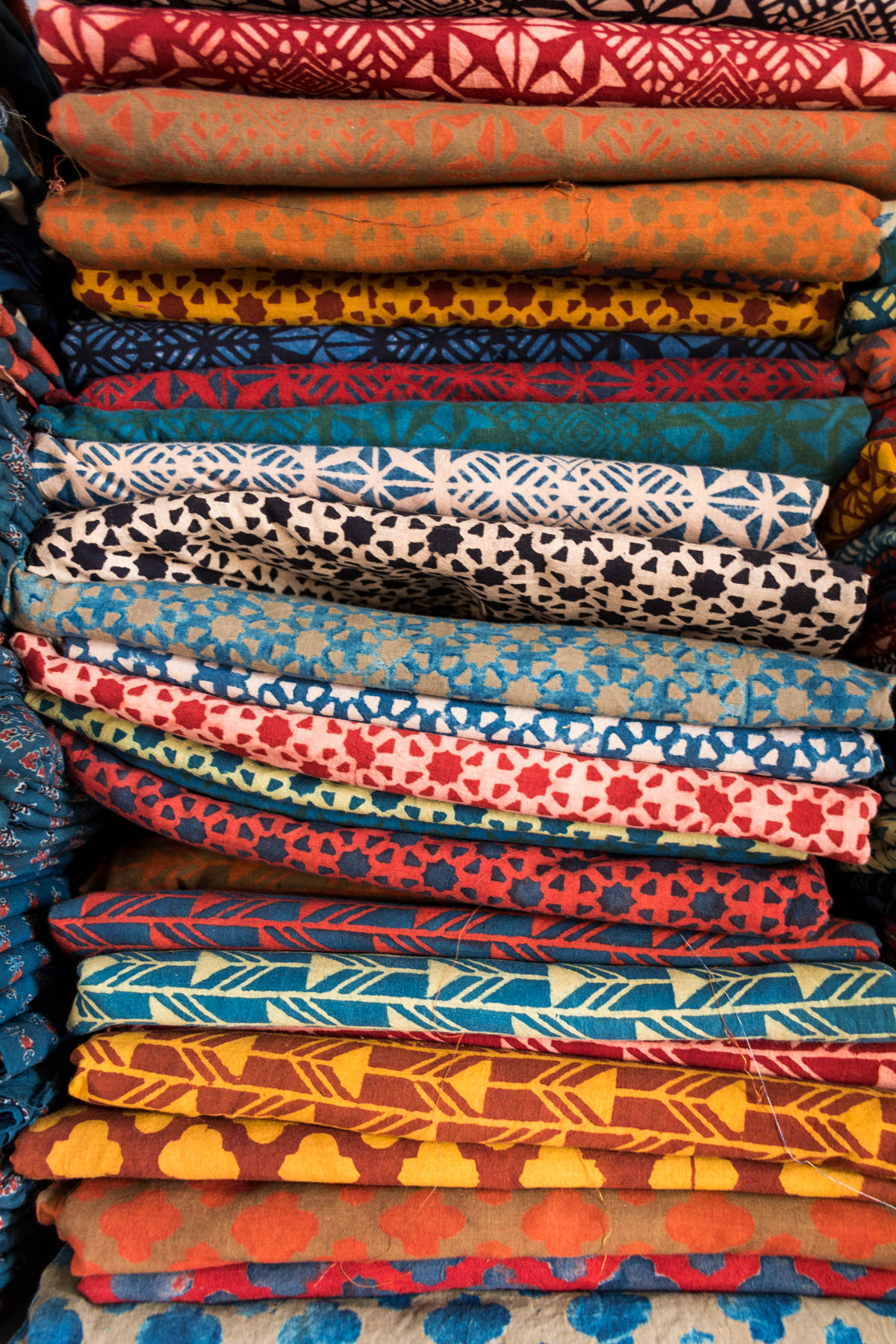 A colorful stack of Ajrakh fabric block printed by hand in Ajrakhpur. Ajrakhpur is a small Kutch village famous for its textiles near Bhuj in Gujarat state, India.