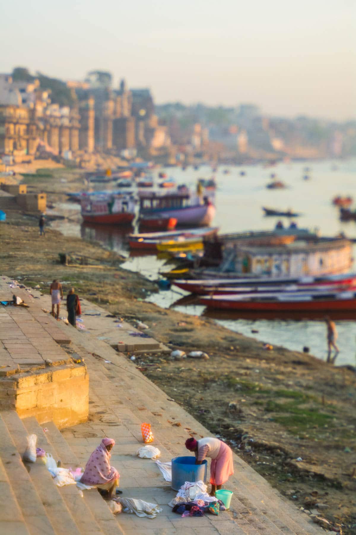 Men doing laundry by the Ganges river in Varanasi, India at sunrise. Shot with a Lensbaby Edge 50 Optic.