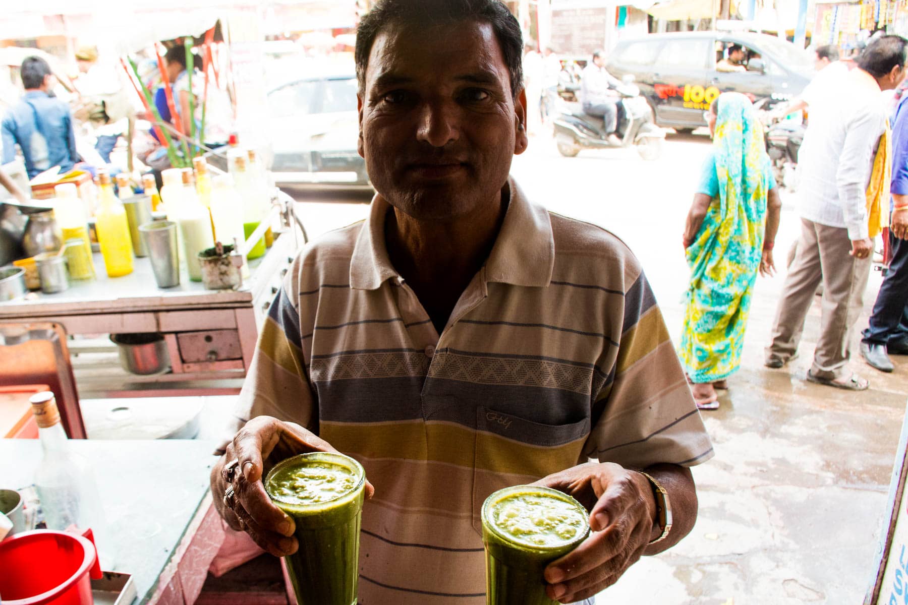 Where to find bhang lassi in Varanasi, India - Vendor selling glasses of bhang thandai in Badal Thandai in Varanasi - Lost With Purpose