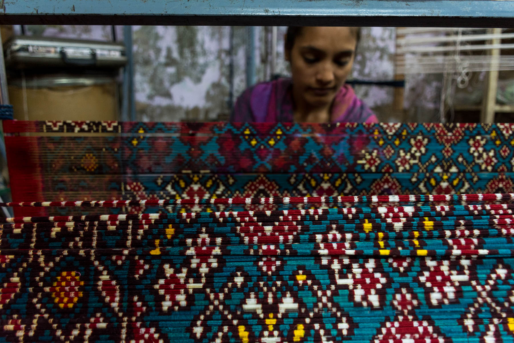 History of Patan Patola in Gujarat, India - A girl unwrapping Patola threads - Lost With Purpose