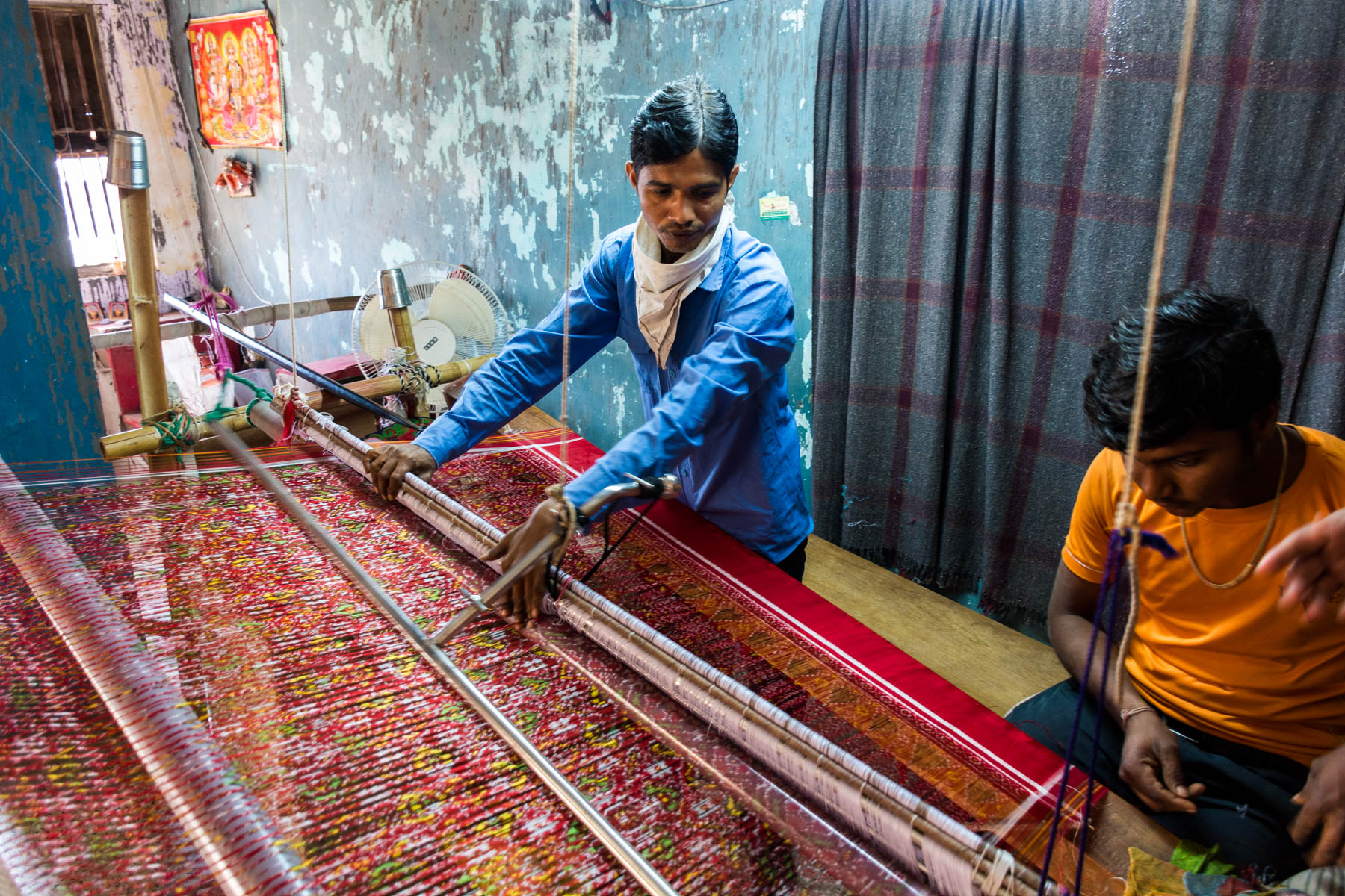 History of Patan Patola - A man in the workshop weaving a Patola on a loom - Lost With Purpose