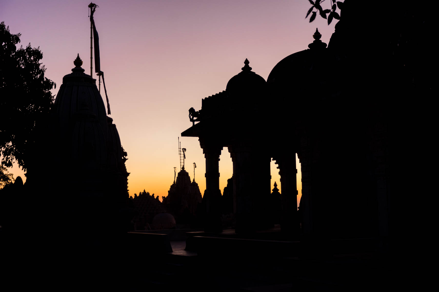 Jain pilgrimage in Palitana, India - Temple silhouettes at sunrise - Lost With Purpose