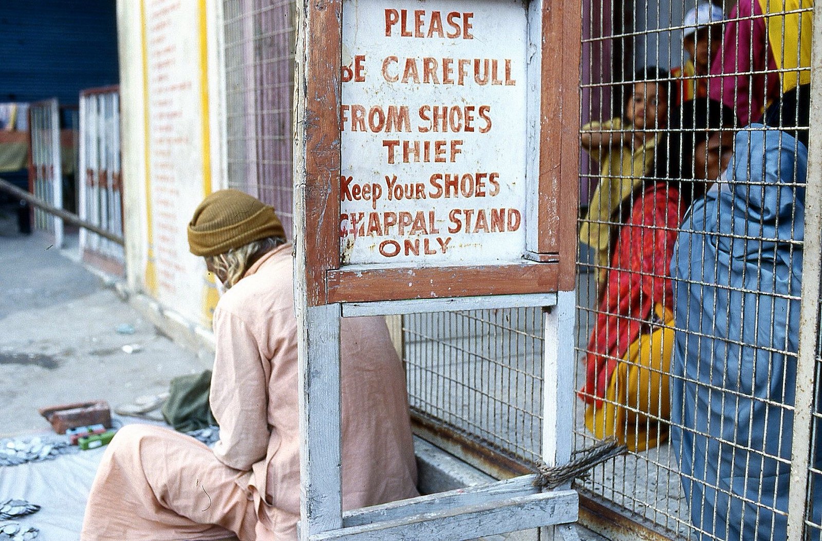 What is baksheesh? - A legitimate shoe keeper in India by Flickr user Nick Kenrick