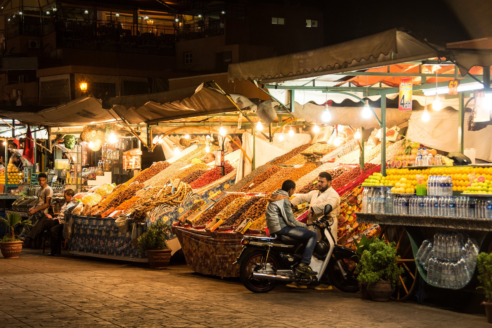 What is baksheesh and where is it found? - Men standing in the Jeema el-Fnaa bazaar at night in Marrakesh, Morocco - Lost With Purpose