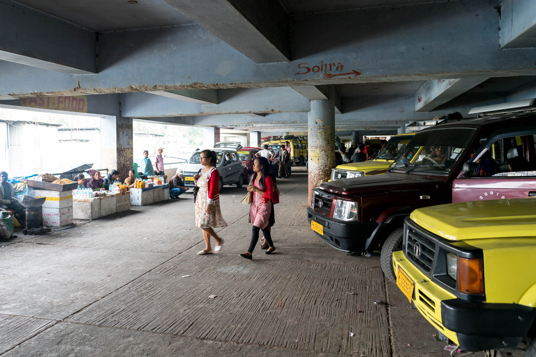 Girl walking in the shared Sumo stand in a parking garage in Shillong