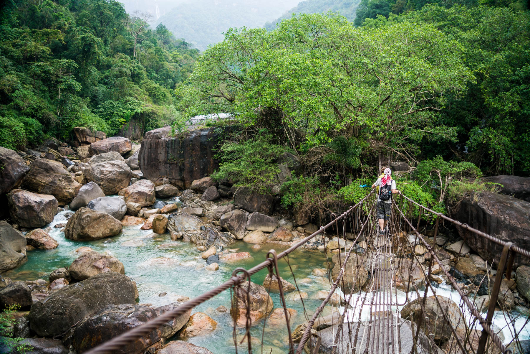 Crossing a suspension bridge near Nongriat