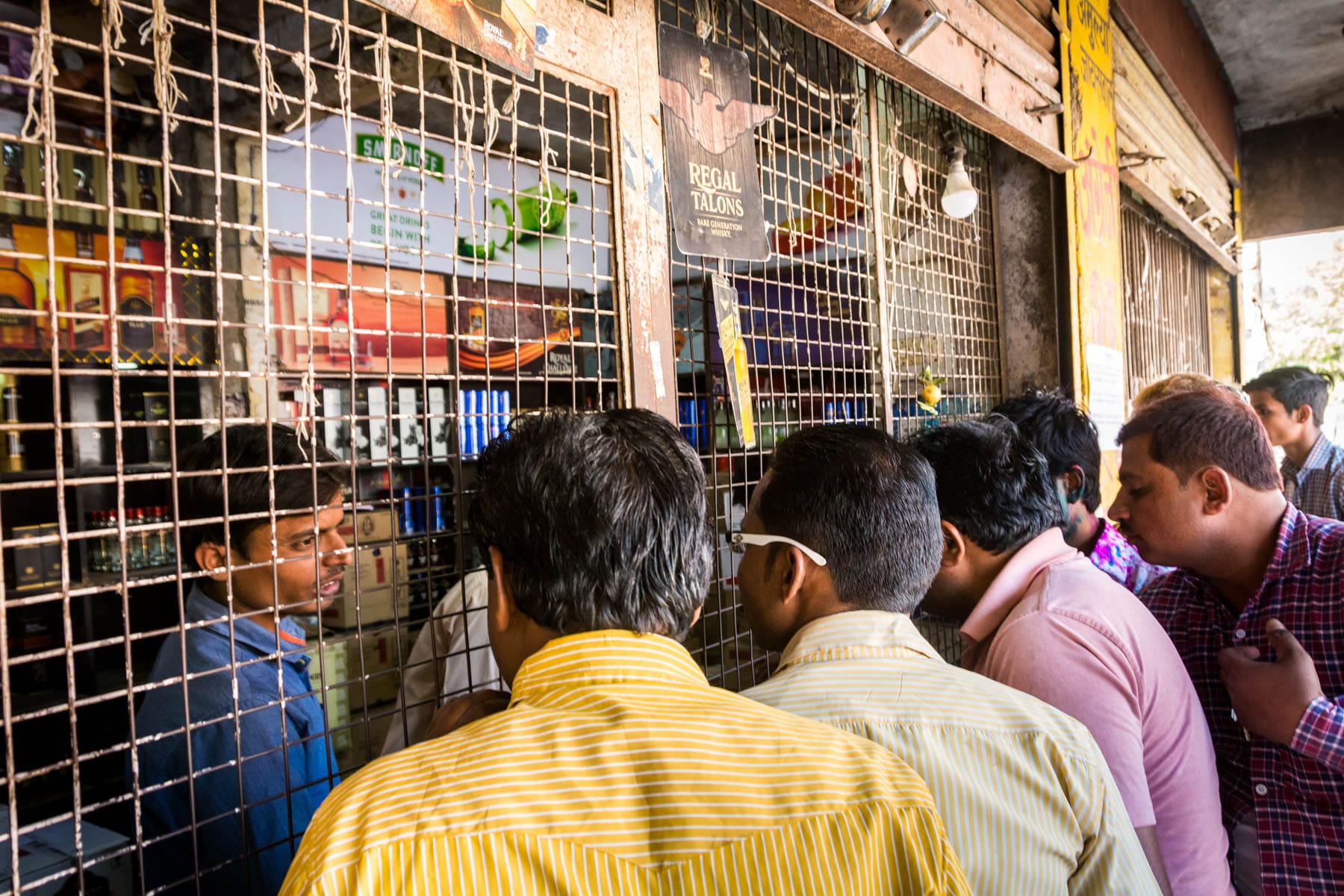 What you need know about playing Holi in Varanasi, India - Crowd at the wine shop in Varanasi before Holi - Lost With Purpose