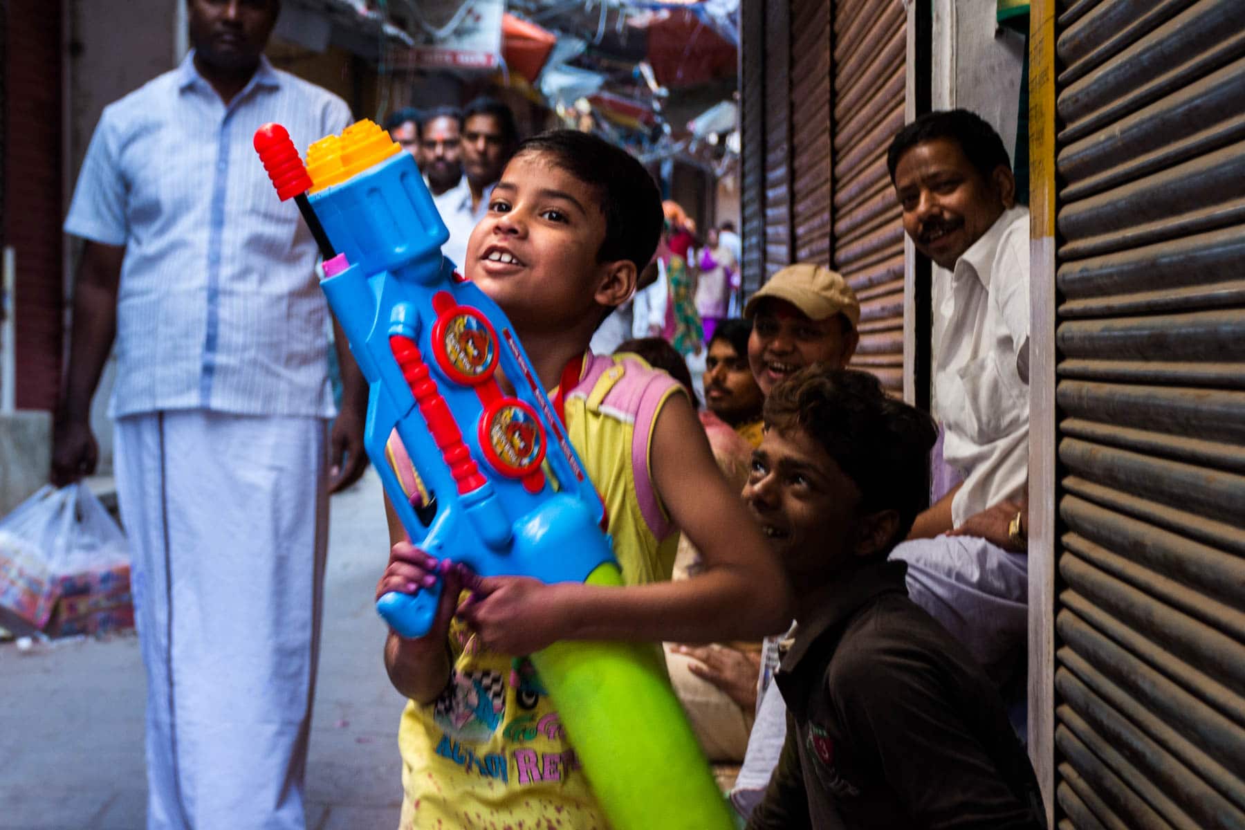Celebrating Holi as a woman in Varanasi, India - Boy with water gun - Lost With Purpose