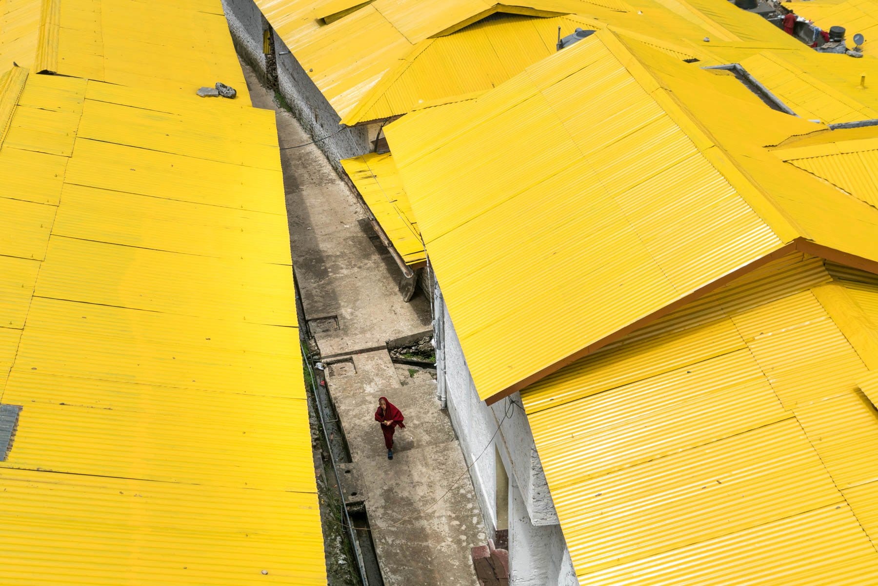 Backpacking Arunachal Pradesh travel guide - A young monk walking in Tawang Monastery - Lost With Purpose