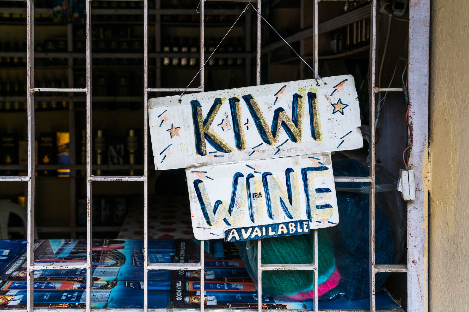 Backpacking in Arunachal Pradesh travel guide - Kiwi wine sign in Bomdila - Lost With Purpose