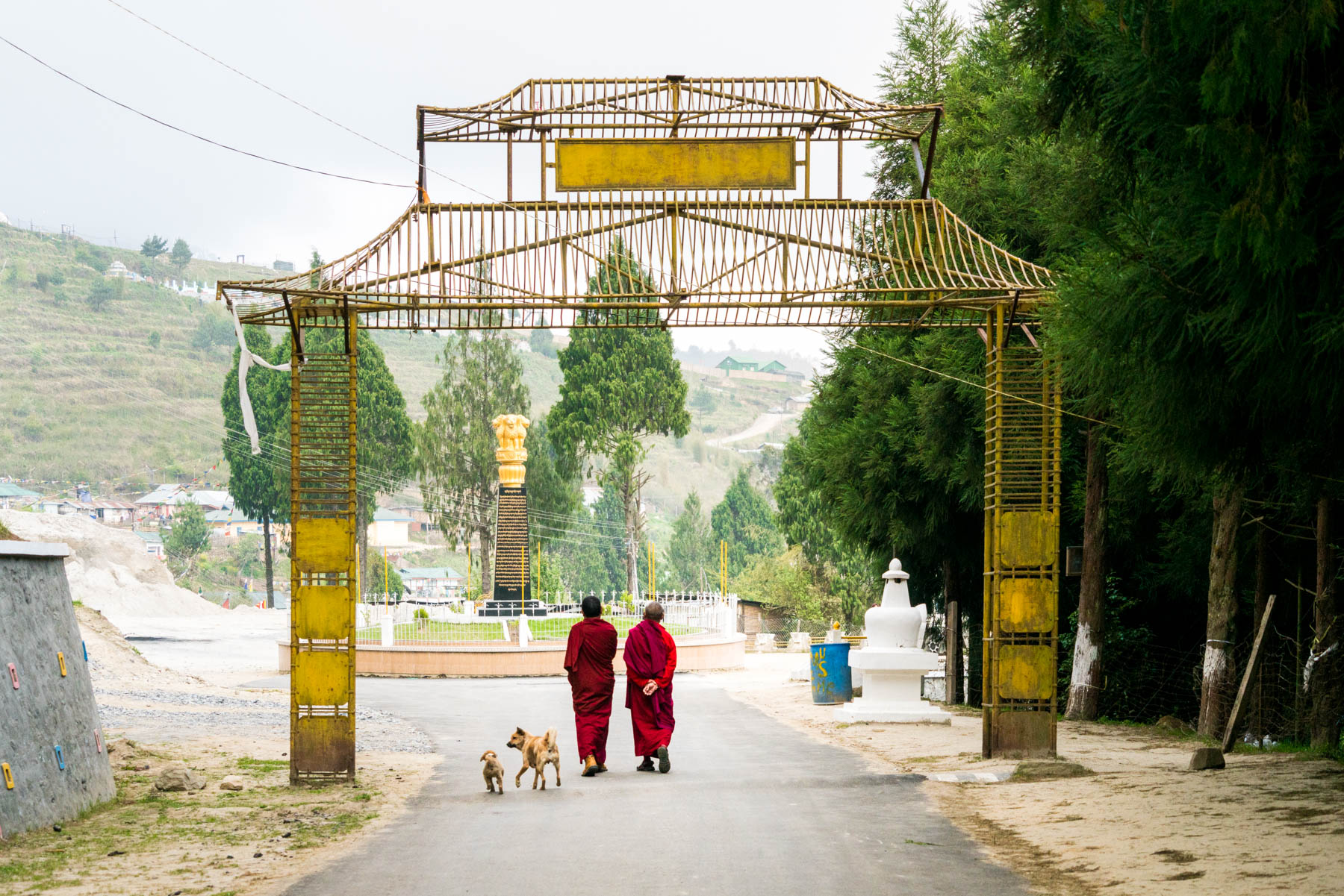 Backpacking in Arunachal Pradesh travel guide - Monks walking through a gate at the Upper Gompa in Bomdila - Lost With Purpose