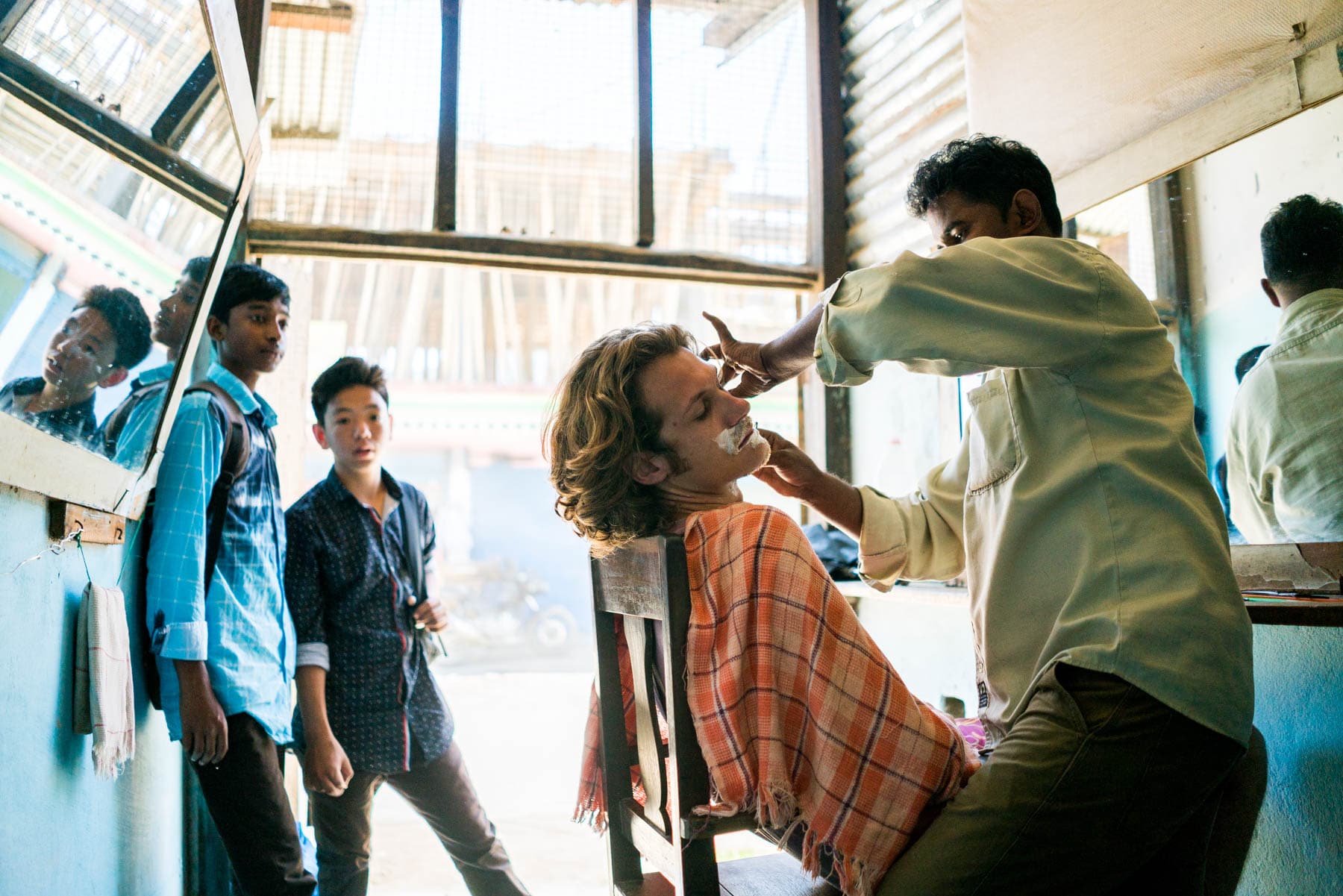 Backpacking in Arunachal Pradesh, India - Sebastiaan getting a cheap shave in Daporijo - Lost With Purpose