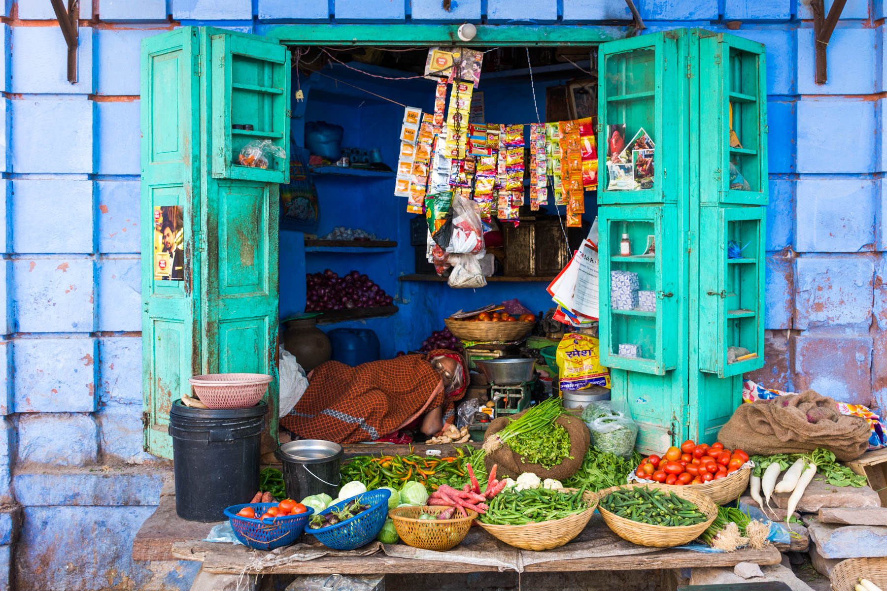 Sleeping aunty storekeeper in a blue storefront