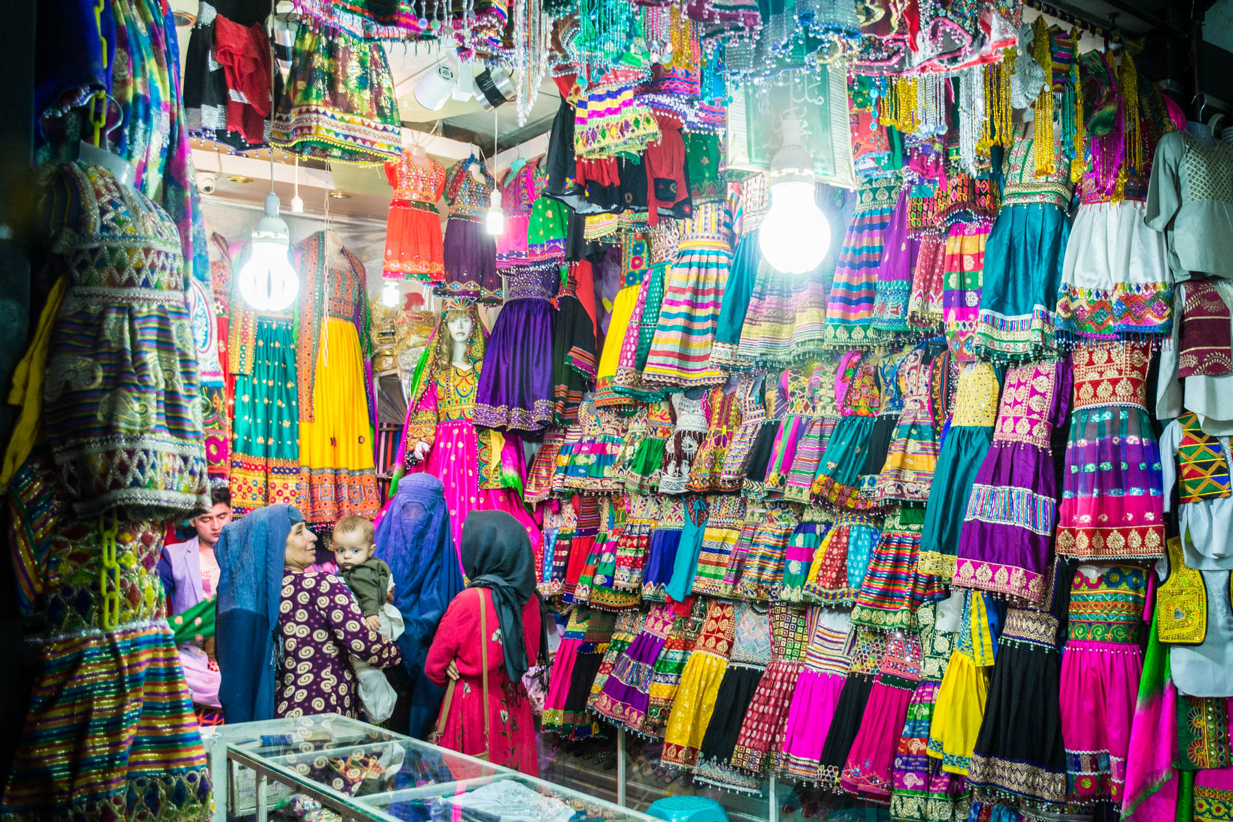 Photos of Mazar-i-Sharif, Afghanistan - Women in burqa shopping for colorful clothes in the central bazar - Lost With Purpose