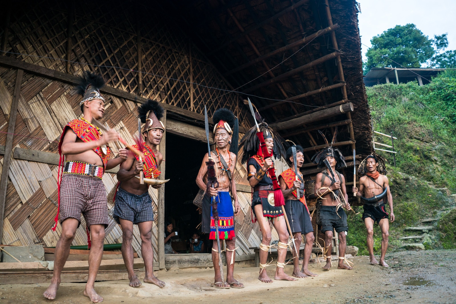 Snapshots of traditional Konyak tribal culture in Longwa village, Nagaland, Northeast India - Line of Longwa men in traditional attire - Lost With Purpose Travel Blog