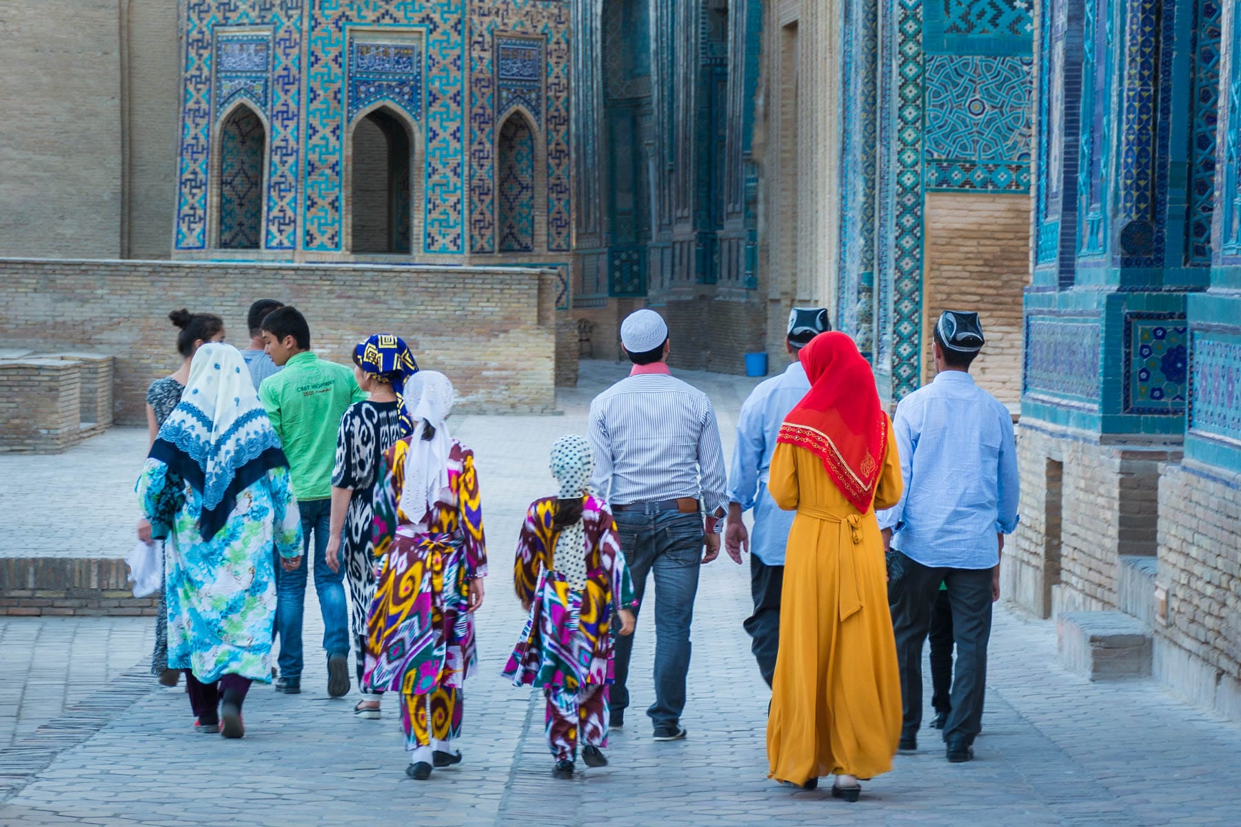 Family walking around in traditional Uzbek clothes in Samarkand -