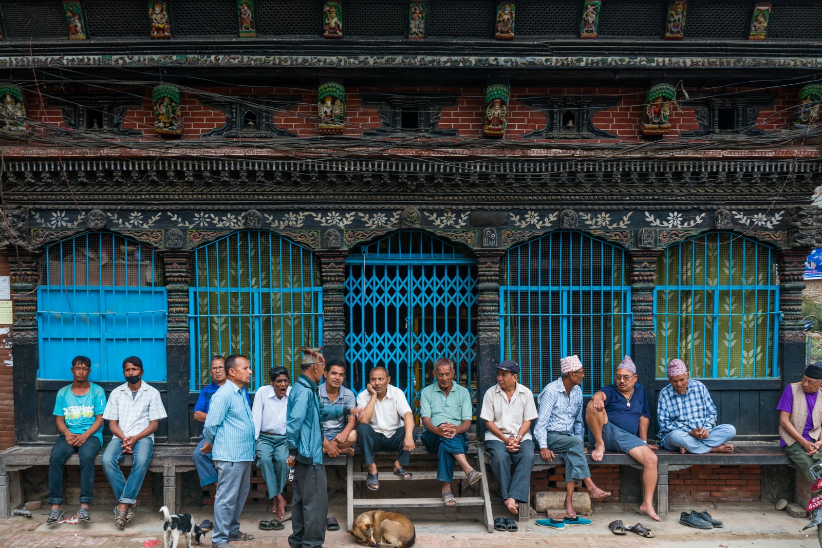 Traveling in Patan, Nepal during monsoon - Men chilling on the streets of Patan - Lost With Purpose travel blog