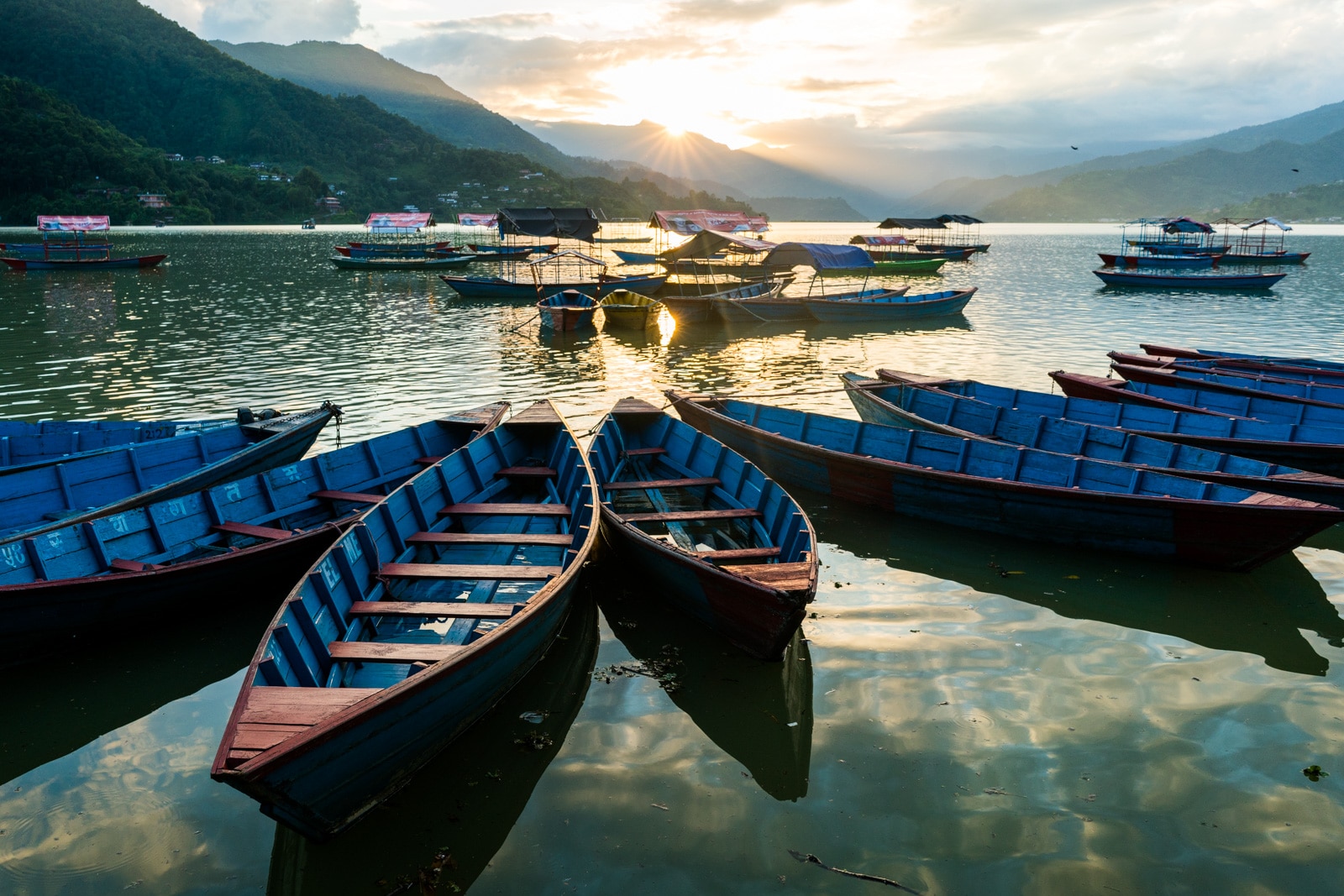 What it's like to travel in Nepal during monsoon - Blue boats on Phewa lake in Pokhara - Lost With Purpose travel blog