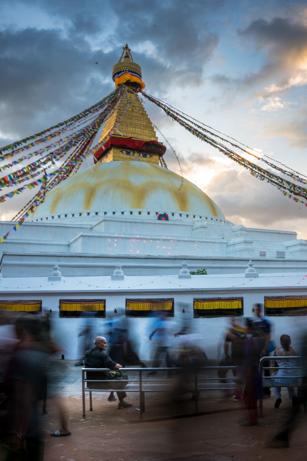 Top places to visit in Kathmandu, Nepal during monsoon - A man sitting still at Boudhanath stupa in Kathmandu - Lost With Purpose travel blog