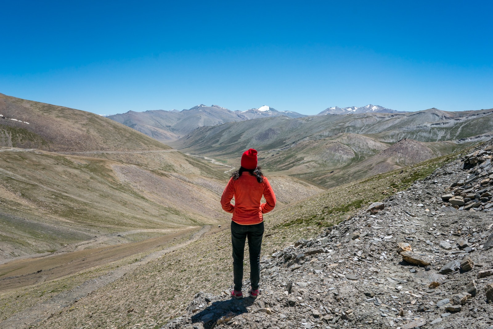 Hitchhiking the Leh - Manali highway - Alex looking over a valley after Taglang La - Lost With Purpose travel blog