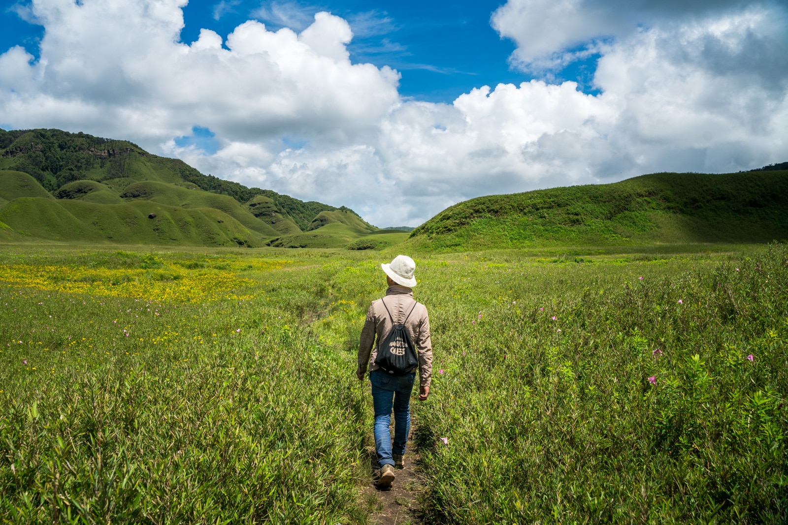 Why you need to travel in Northeast India - Guide walking through the hills of Dzukou Valley in Nagaland and Manipur - Lost With Purpose travel blog