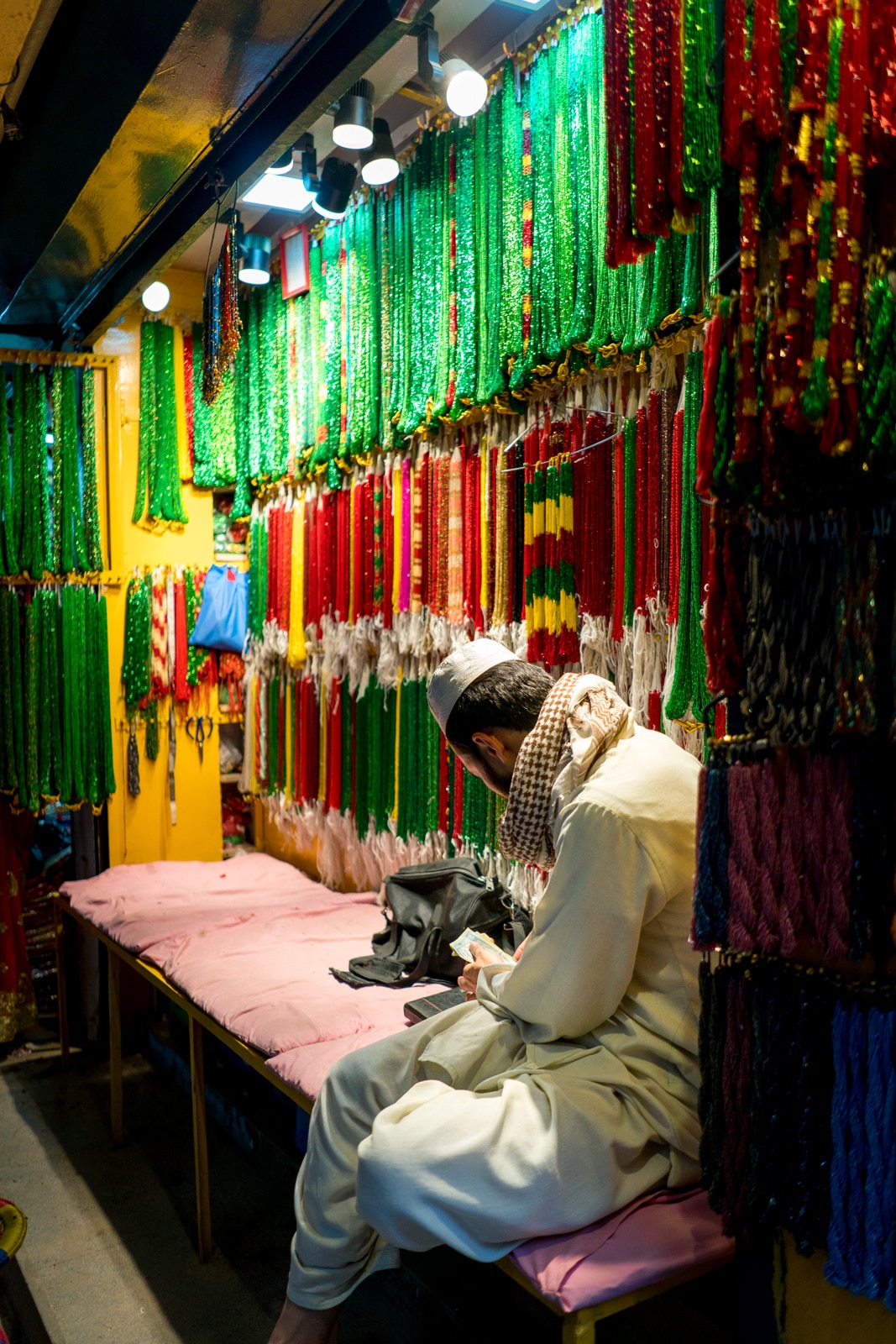 A man selling colorful jewelry in the New Market area of Kathmandu, Nepal.