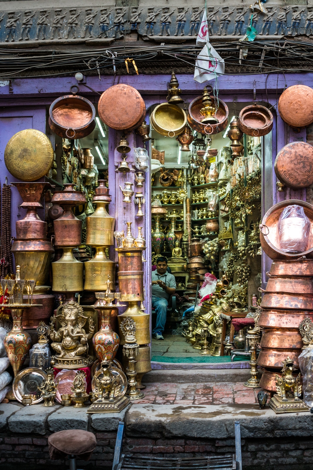 A store filled to the brim with brass and copper knick knacks in the New Market area of Kathmandu, Nepal.