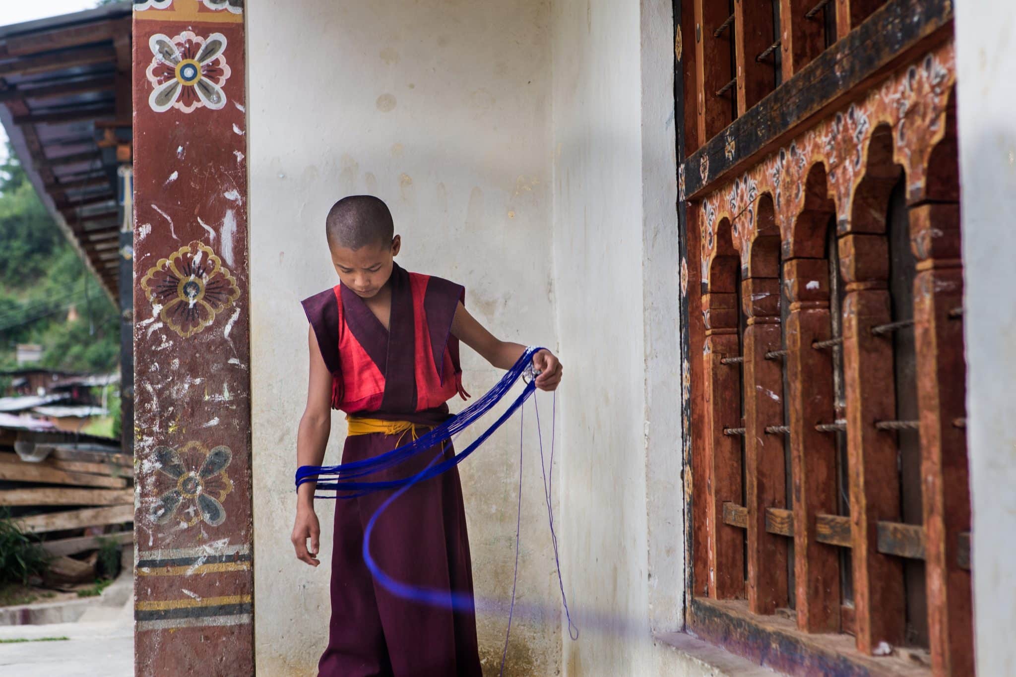 We're traveling to Bhutan - A monk with string by Gray Langur Tours