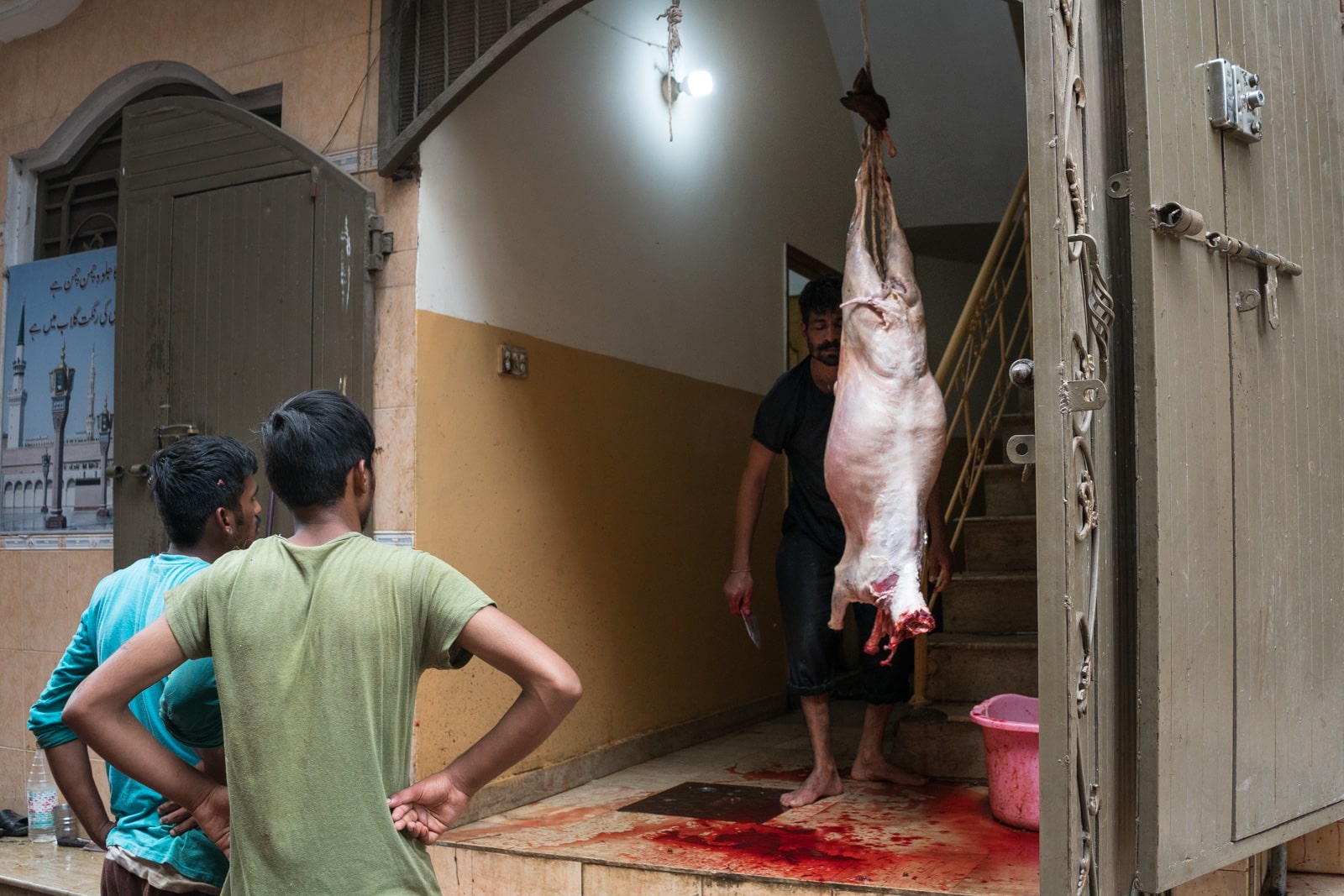 Celebrating Eid al-Adha in Lahore, Pakistan - Goat being skinned in a house - Lost With Purpose travel blog