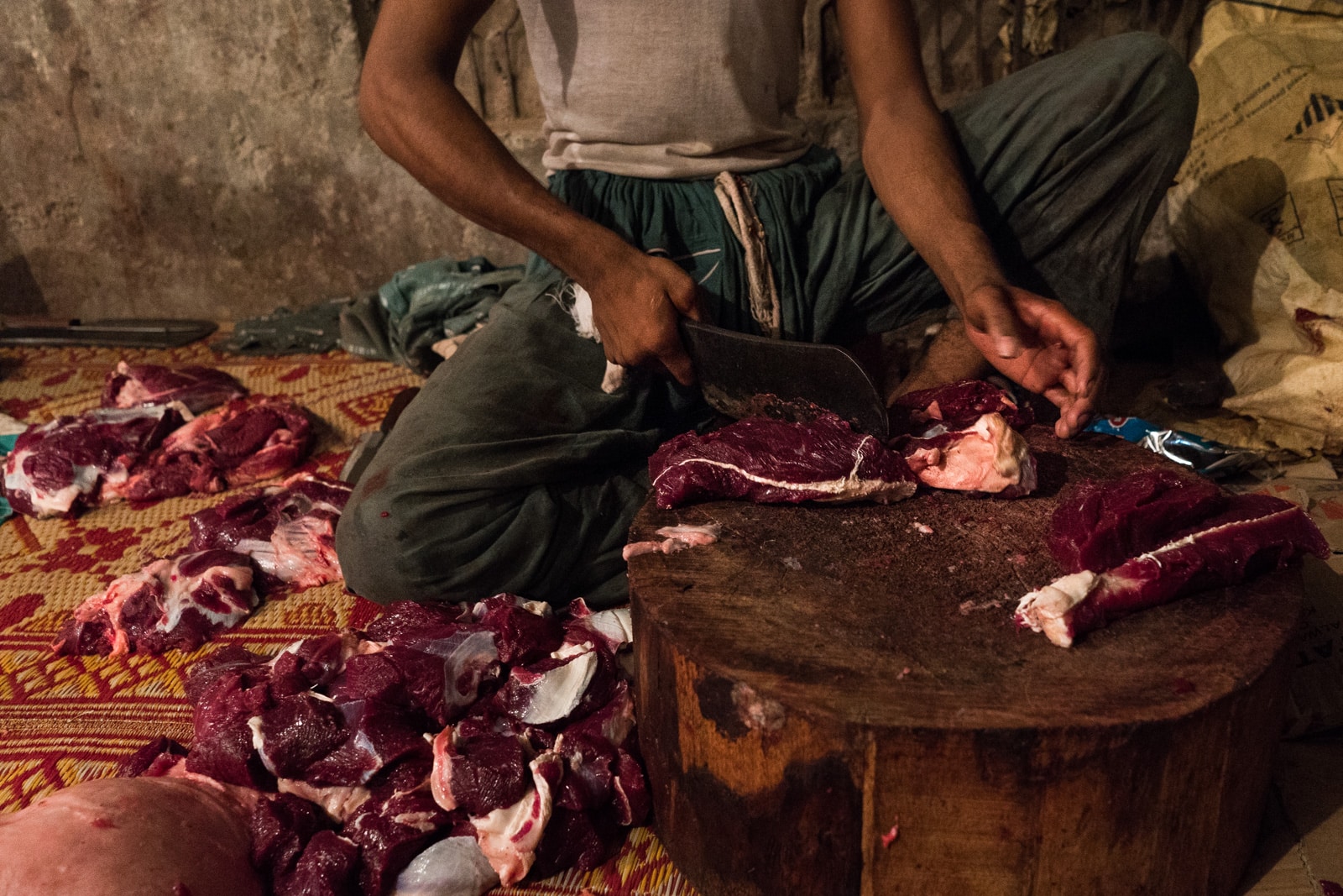 Celebrating Eid al-Adha in Lahore, Pakistan - A man chopping up camel meat - Lost With Purpose travel blog