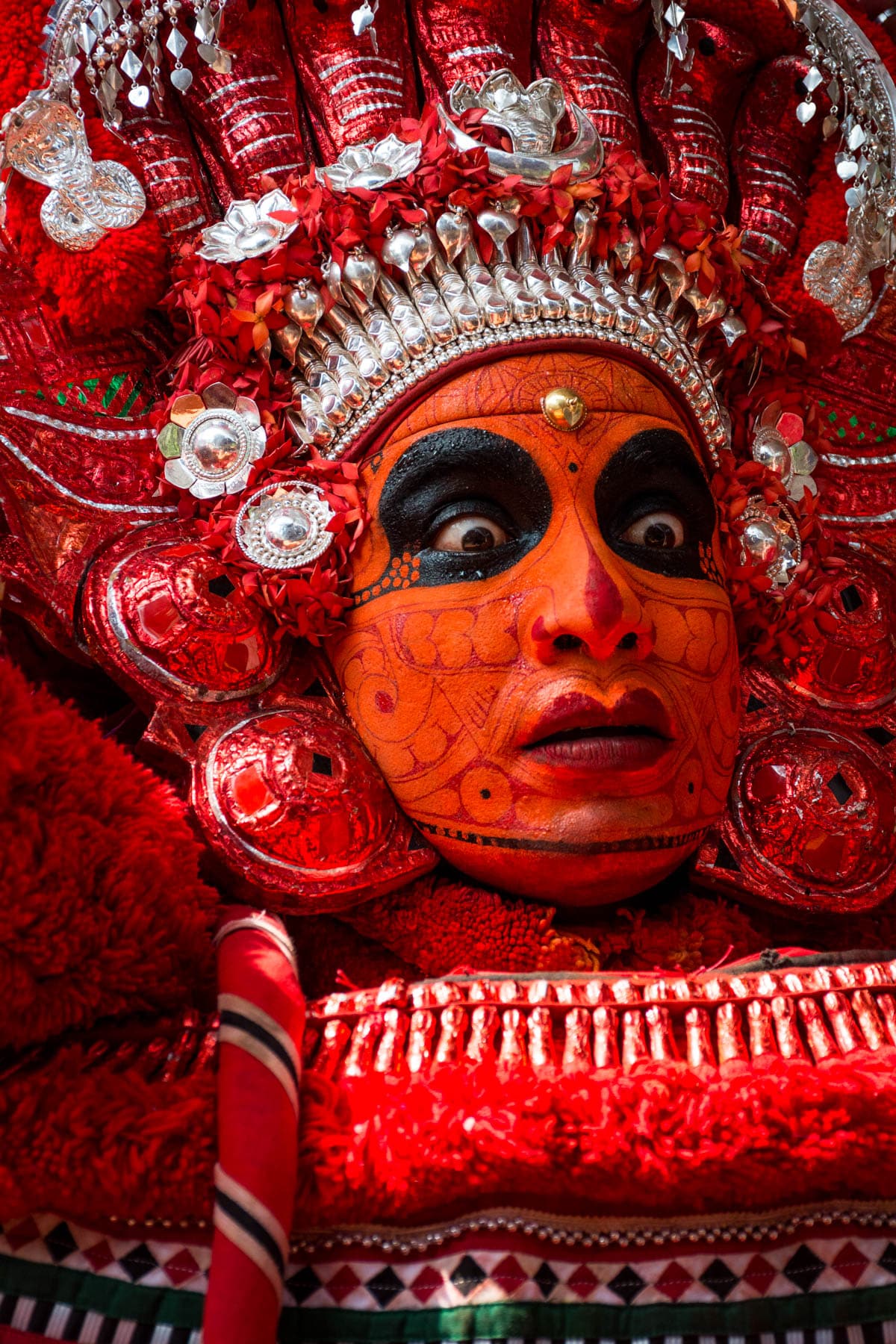 Portrait of a Theyyam dancer in full face paint during Theyyam season in Kannur, Kerala state, India.