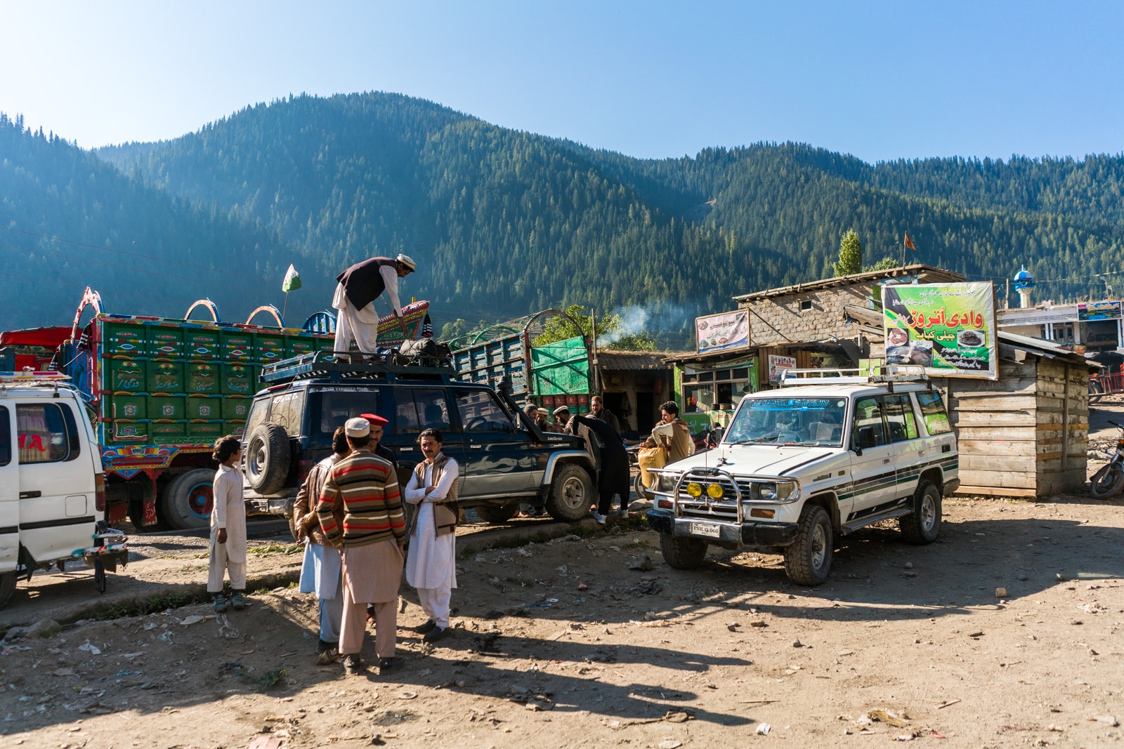 Men loading up shared taxis with supplies in Utrar, Pakistan