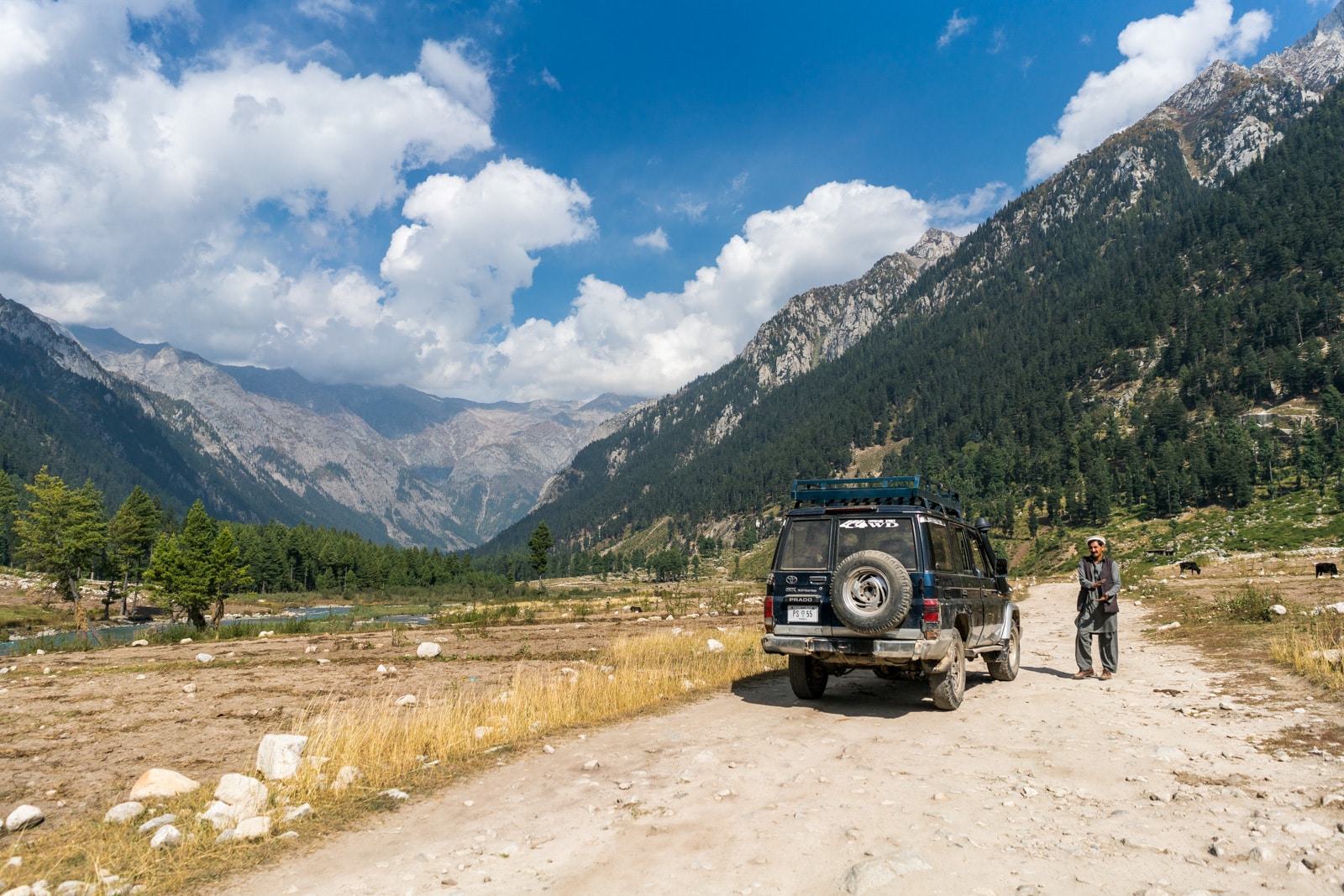 A driver standing next to his Jeep enroute to Kumrat Valley in Pakistan